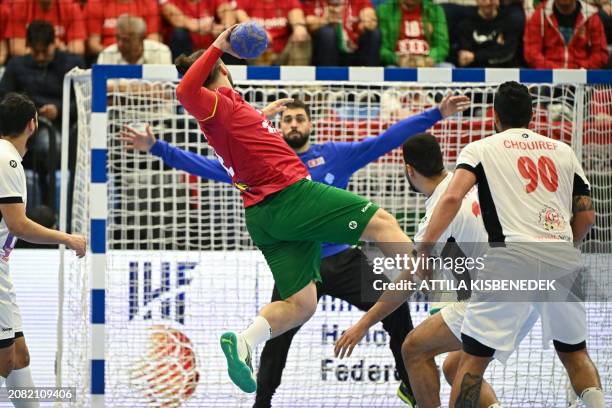 Portugal's Luis Frade scores during the men's Handball Olympic qualifying match between Portugal and Tunisia in Tatabanya, Hungary on March 16, 2024.