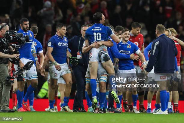 Italy's teammates celebrate after winning at the end of the Six Nations international rugby union match between Wales and Italy at the Principality...