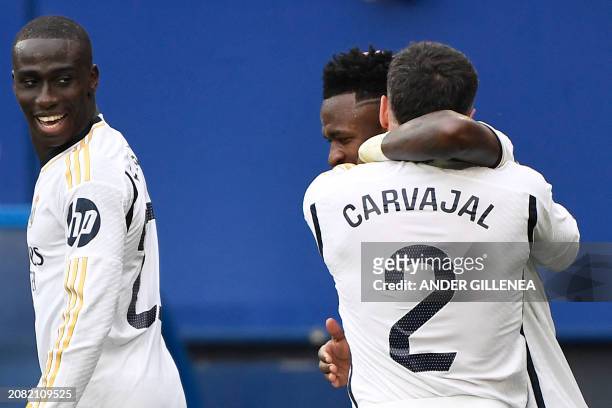 Real Madrid's French defender Ferland Mendy looks at Real Madrid's Brazilian forward Vinicius Junior celebrating his second goal with Real Madrid's...