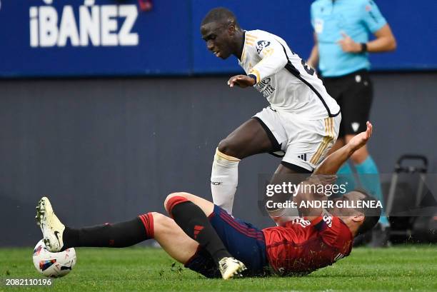 Real Madrid's French defender Ferland Mendy and Osasuna's Spanish defender Unai Garcia vie for the ball during the Spanish league football match...