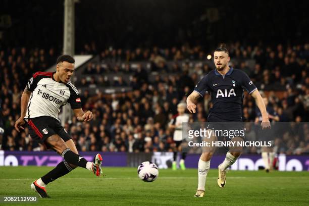 Fulham's Brazilian striker Rodrigo Muniz shoots to score the opening goal of the English Premier League football match between Fulham and Tottenham...