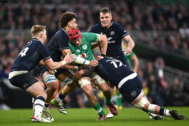 Dublin , Ireland - 16 March 2024; Josh van der Flier of Ireland is tackled by Scotland players, from left, Kyle Steyn, Andy Christie, and Rory...