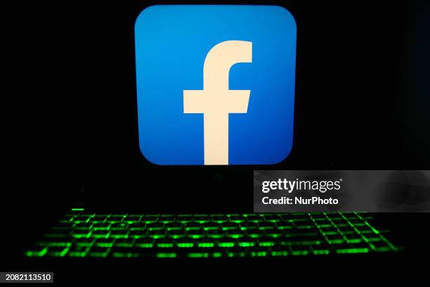 The Facebook logo is displayed on a laptop screen with a glowing keyboard in Krakow, Poland, on March 3, 2024.