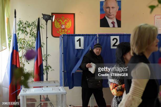 Man votes in Russia's presidential election at a polling station in Donetsk, Russian-controlled Ukraine, amid the Russia-Ukraine conflict on March...