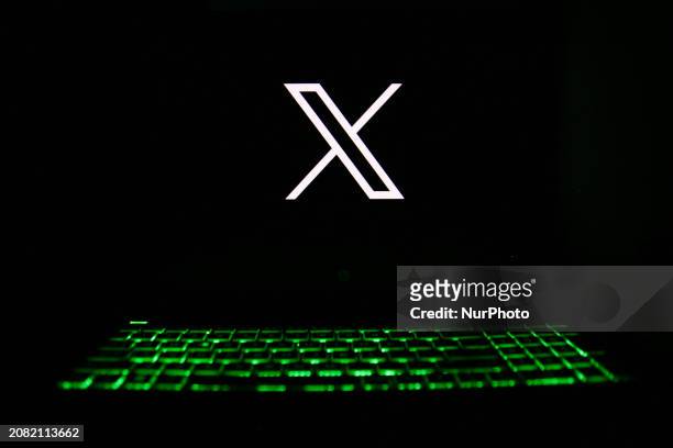 The X logo is being displayed on a laptop screen with a glowing keyboard in Krakow, Poland, on March 3, 2024.
