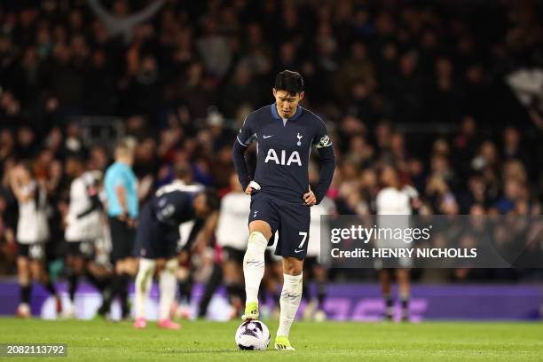 Tottenham Hotspur's South Korean striker Son Heung-Min reacts as Fulham players celebrate their second goal during the English Premier League...