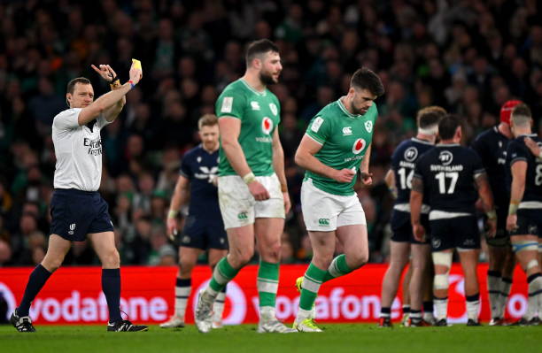 Dublin , Ireland - 16 March 2024; Harry Byrne of Ireland, right, is shown a yellow card by referee Matthew Carley during the Guinness Six Nations...