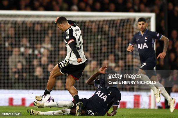 Tottenham Hotspur's Senegalese midfielder Pape Matar Sarr fouls Fulham's English-born US defender Antonee Robinson during the English Premier League...