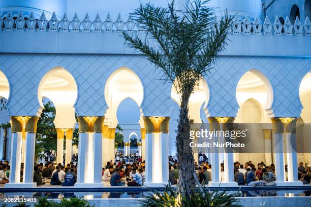 Muslims are breaking their fast on the first day of the Muslim holy fasting month of Ramadan at the Sheikh Zayed Grand Mosque in Surakarta, Central...
