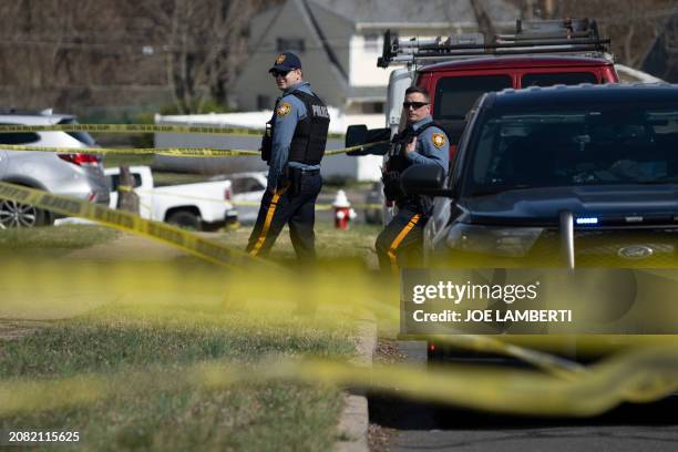 Police guard a home during an active shooter situation in Levittown, a community within Falls Township, Pennsylvania, on March 16, 2024. Three people...