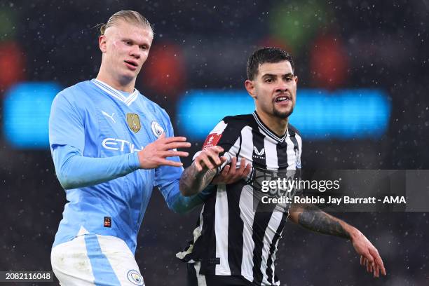 Erling Haaland of Manchester City tussles with Bruno Guimaraes of Newcastle United during the Emirates FA Cup Quarter Final match between Manchester...