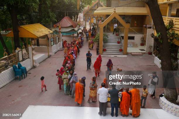 Buddhist monks are distributing iftar food to underprivileged Muslims at a Buddhist temple to help them break their fast during the Islamic holy...
