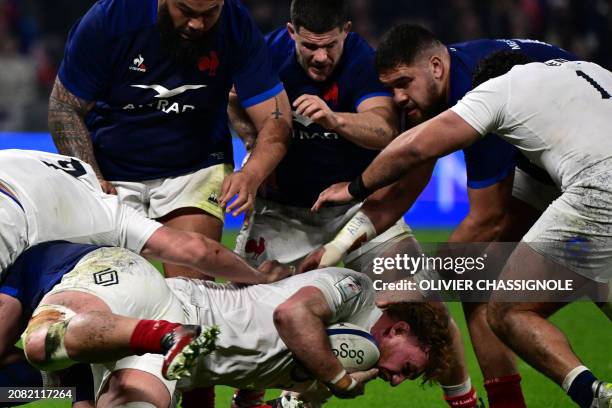 England's flanker Ollie Chessum goes to the ground under the threat of France's prop Uini Atonio , France's hooker Julien Marchand and France's lock...