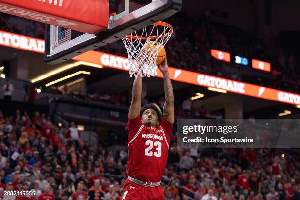 Wisconsin Badgers guard Chucky Hepburn dunks the ball during the second half of a Big Ten Men's Basketball Tournament semi finals game between the...