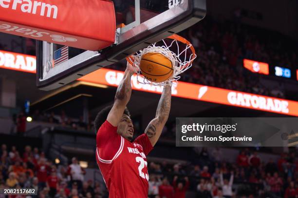 Wisconsin Badgers guard Chucky Hepburn dunks the ball during the second half of a Big Ten Men's Basketball Tournament semi finals game between the...