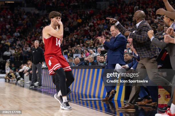 Wisconsin Badgers forward Carter Gilmore celebrates scoring during the second half of a Big Ten Men's Basketball Tournament semi finals game between...