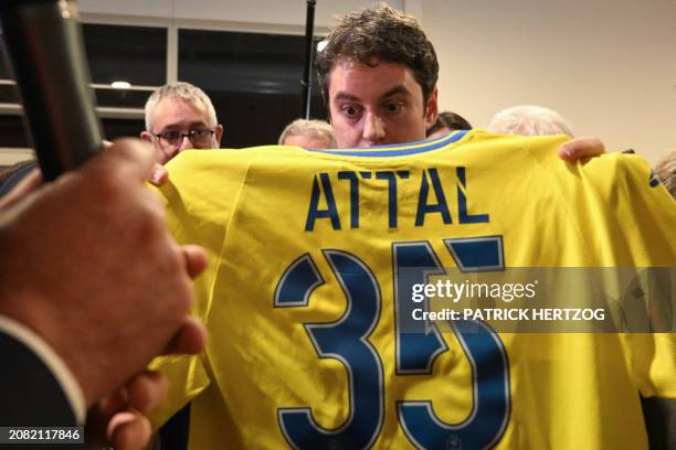 France's Prime Minister Gabriel Attal displays a FC Sochaux-Montbeliard football jersey bearing his name and the number "35" to mark his 35th...