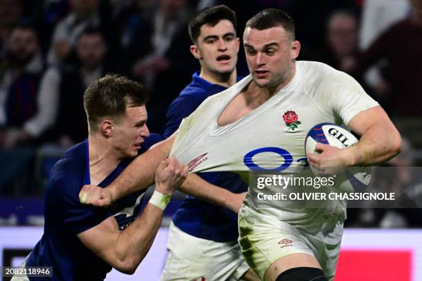 England's back row Ben Earl is tackled by France's full-back Leo Barre during the Six Nations international rugby union match between France and...