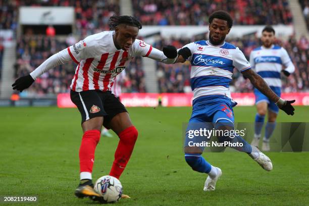 Romaine Mundle of Sunderland is attempting a cross while under pressure from Kenneth Paal of QPR during the Sky Bet Championship match between...