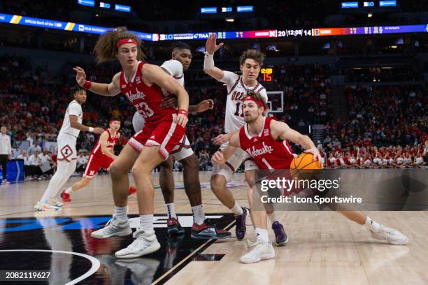 Nebraska Cornhuskers guard Sam Hoiberg drives to the basket while being defended by Illinois Fighting Illini guard Niccolo Moretti during the first...