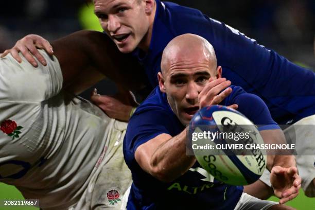 France's scrum-half Maxime Lucu clears the ball out of a ruck during the Six Nations international rugby union match between France and England at...