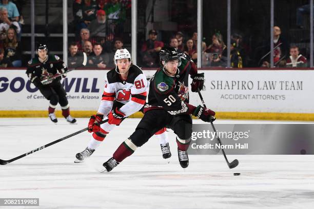 Sean Durzi of the Arizona Coyotes skates up the ice with the puck during the first period of the game against the New Jersey Devils at Mullett Arena...