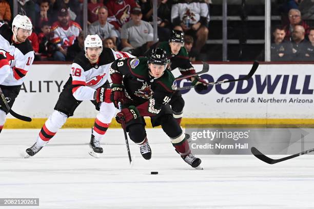 John Leonard of the Arizona Coyotes skates up the ice with the puck during the first period of the game against the New Jersey Devils at Mullett...