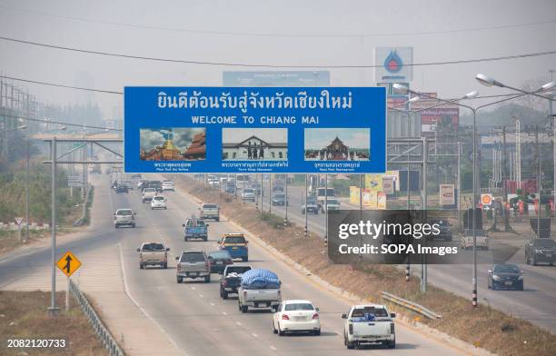 Cars drive along a road amid smog from heavy concentrations of fine particulates matter PM2.5, in Chiang Mai. Air pollution haze in Chiang Mai On...