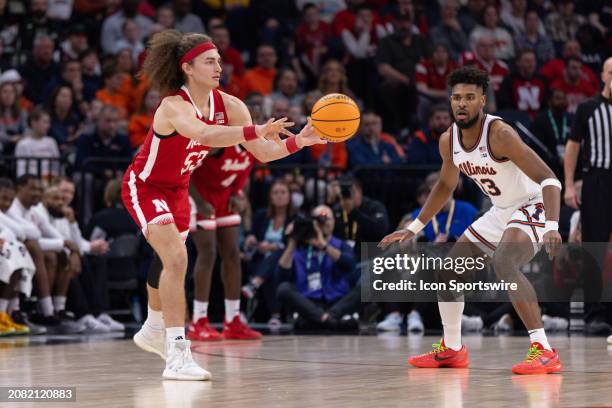 Nebraska Cornhuskers forward Josiah Allick passes the ball while being defended by Illinois Fighting Illini forward Quincy Guerrier during the second...