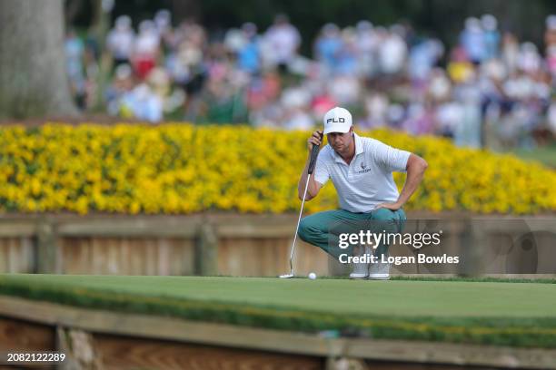 Harris English lines up a putt on the 17th green during the third round of THE PLAYERS Championship at Stadium Course at TPC Sawgrass on March 16,...
