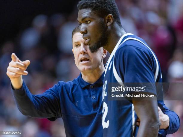 Head coach Brooks Miller of the Trine Thunder talks with Emmanuel Megnanglo of the Trine Thunder during the NCAA Division III Championship against...