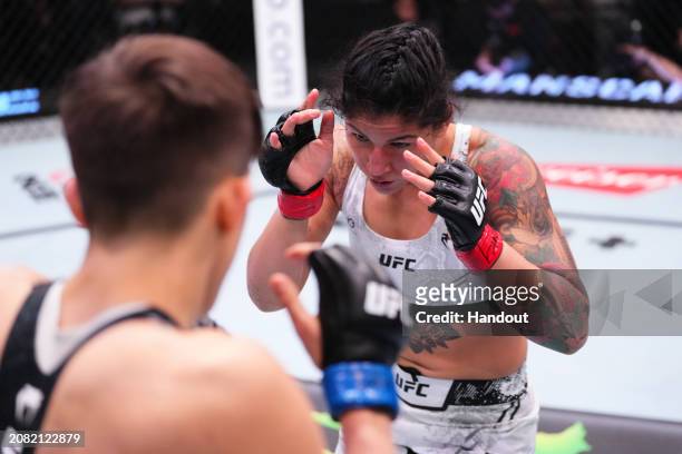 In this handout image provided by UFC, Pannie Kianzad of Iran battles Macy Chiasson in their women's bantamweight fight during the UFC Fight Night...