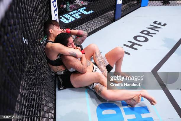 In this handout image provided by UFC, Macy Chiasson attempts to sub Pannie Kianzad of Iran in their women's bantamweight fight during the UFC Fight...