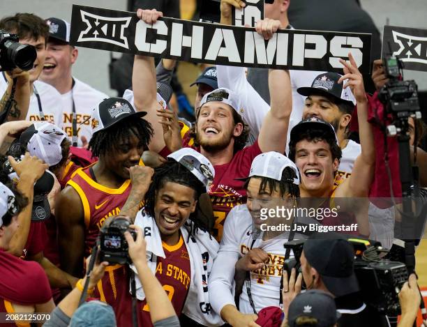 The Iowa State Cyclones celebrate after defeating the Houston Cougars in the Big 12 Men's Basketball Tournament championship game at T-Mobile Center...