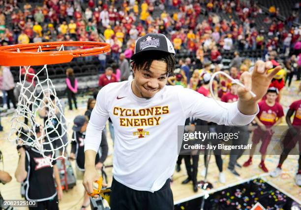 Jelani Hamilton of the Iowa State Cyclones cuts down the net after defeating the Houston Cougars in the Big 12 Men's Basketball Tournament...