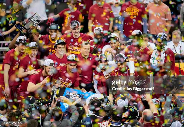 The Iowa State Cyclones celebrate after defeating the Houston Cougars in the Big 12 Men's Basketball Tournament championship game at T-Mobile Center...