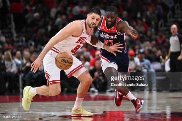 Nikola Vucevic of the Chicago Bulls and Eugene Omoruyi of the Washington Wizards battle for control of a loose ball in the first half on March 16,...
