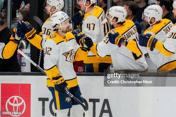 Tommy Novak of the Nashville Predators celebrates with teammates after a goal is scored during the first period of a game against the Seattle Kraken...