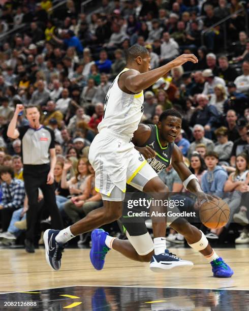 Kris Dunn of the Utah Jazz defends Anthony Edwards of the Minnesota Timberwolves during the first half of a game at Delta Center on March 16, 2024 in...