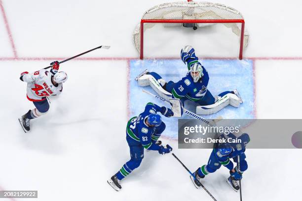 Tom Wilson of the Washington Capitals scores a goal against Casey DeSmith of the Vancouver Canucks during the second period of their NHL game at...