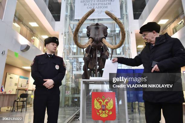 Man casts his ballot in Russia's presidential election in the Siberian city of Novosibirsk on March 17, 2024.