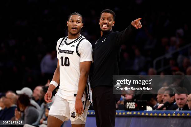 Head coach Kim English of the Providence Friars talks with Rich Barron in the first half against the Georgetown Hoyas during the First Round of the...