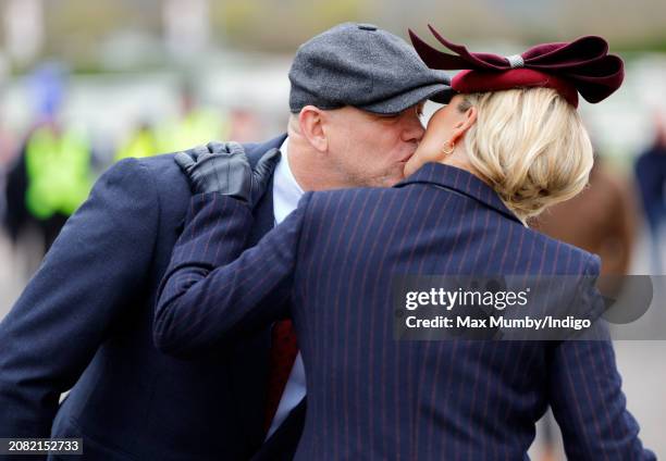 Mike Tindall kisses wife Zara Tindall as they attend day 2 'Style Wednesday' of the Cheltenham Festival at Cheltenham Racecourse on March 13, 2024 in...