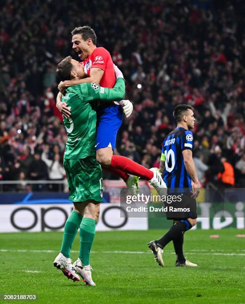 Jan Oblak and Cesar Azpilicueta of Atletico Madrid celebrate following the team's victory in the penalty shoot out during the UEFA Champions League...