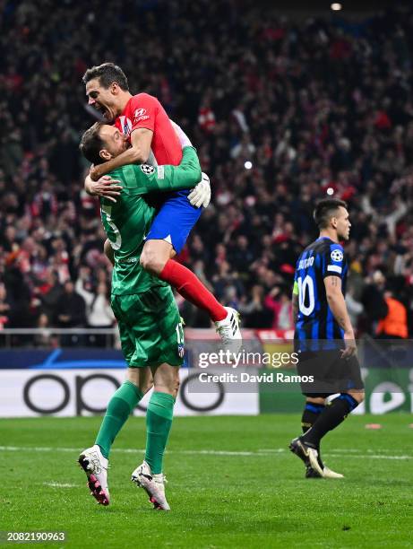 Jan Oblak and Cesar Azpilicueta of Atletico Madrid celebrate following the team's victory in the penalty shoot out during the UEFA Champions League...