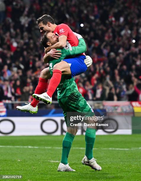 Jan Oblak and Cesar Azpilicueta of Atletico Madrid celebrate following the team's victory in the penalty shoot out during the UEFA Champions League...