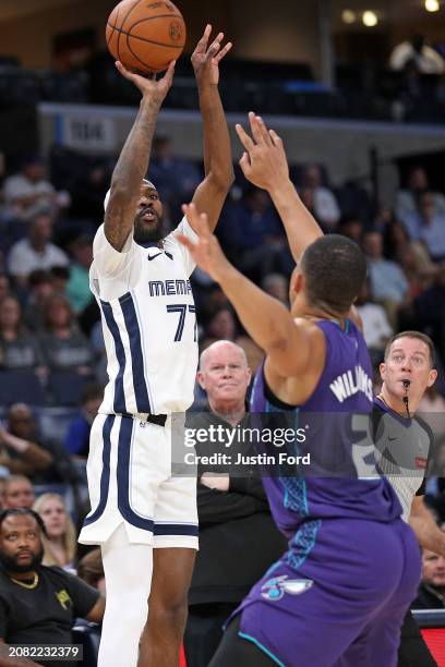 DeJon Jarreau of the Memphis Grizzlies shoots against Grant Williams of the Charlotte Hornets during the first half at FedExForum on March 13, 2024...