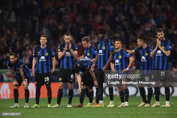 Team mates react as Lautaro Martinez of FC Internazionale embraces Alexis Sanchez on the head after he missed his penalty during the UEFA Champions...