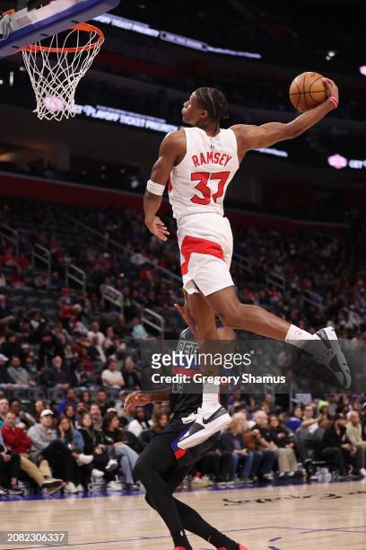 Jahmi'us Ramsey of the Toronto Raptors dunks in front of James Wiseman of the Detroit Pistons during the second half at Little Caesars Arena on March...