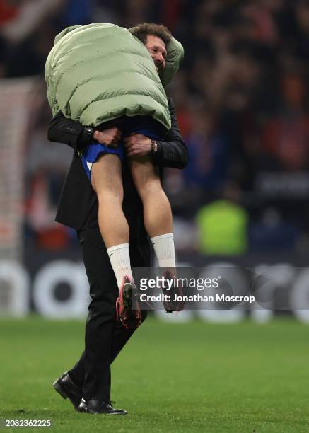 Diego Simeone Head coach of Atletico Madrid lifts Antoine Griezmann of Atletico Madrid on his shoulder following the penalty shoot out victory in the...